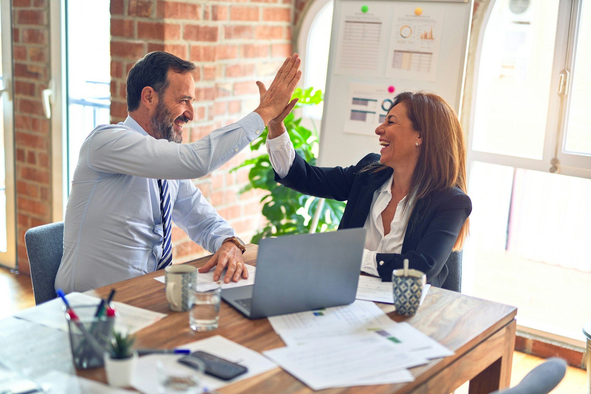 Procurement professionals closing a sourcing partnership
